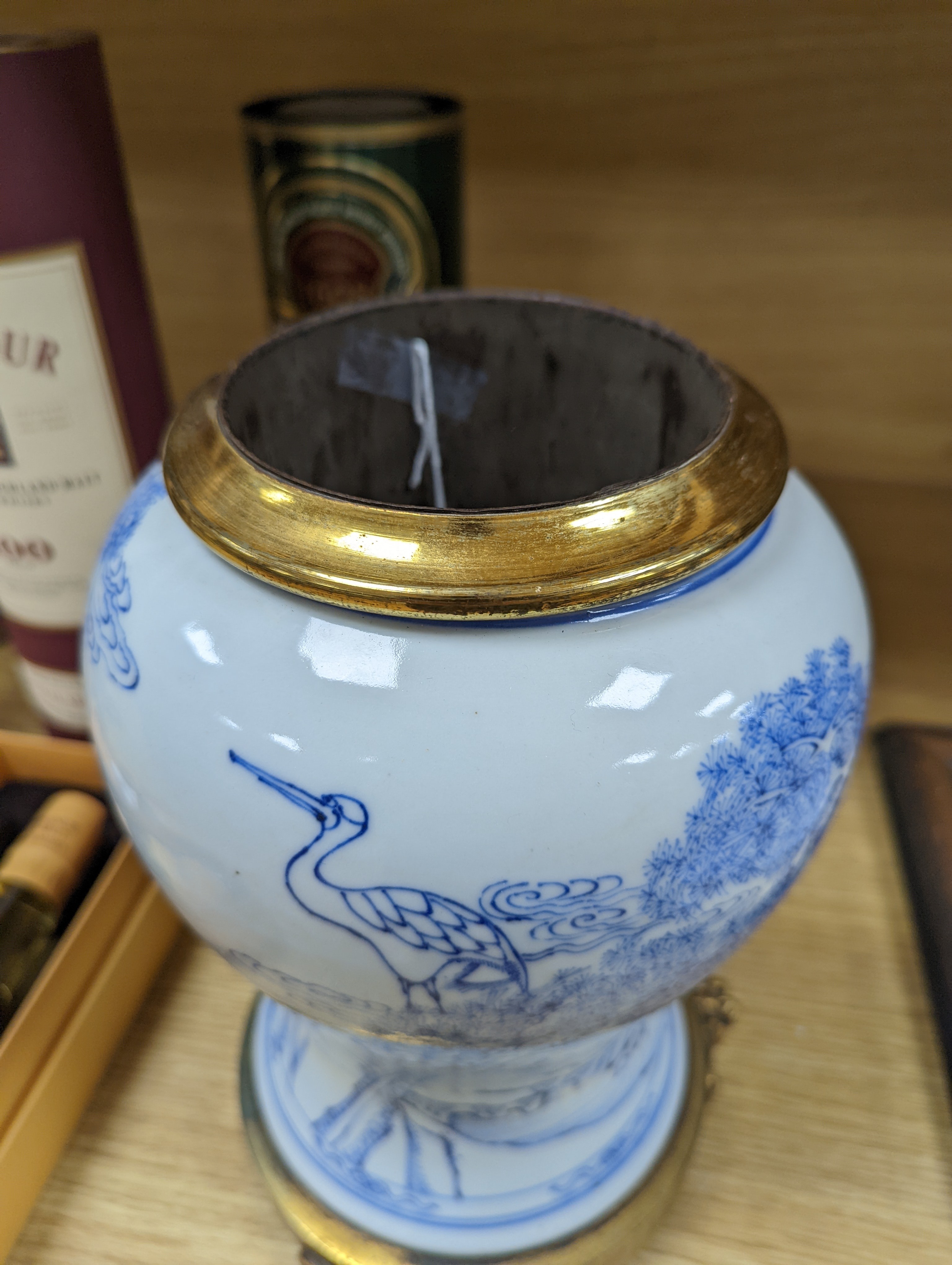 A Chinese blue and white baluster vase, brass mounted 29cm